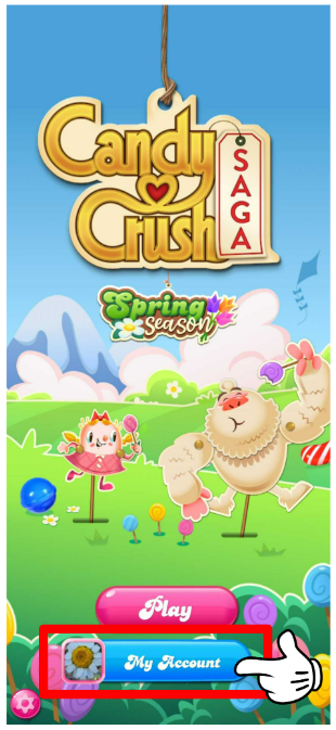 The starting screen in Candy Crush Saga. The game's name hangs by a string in the upper part of the screen. Tiffi and Yeti are playing in a meadow and eating candies. There are two buttons: a pink Play button and a blue button that reads "My account"